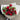 A bouquet of red roses wrapped in white paper with green leaves accent by a Melbourne florist - Florist Corner