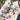 Bouquet of flowers with white and pink roses on a white paper background.